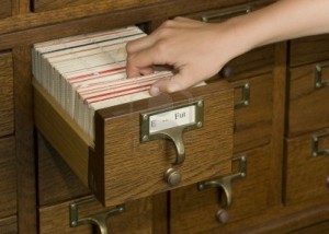 hand-reaching-into-a-card-catalog-file-drawer